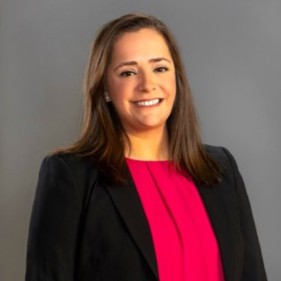 Kim Calabro, Senior Manager, Immigration Services at Integreon seen in pink and black color formal office outfit